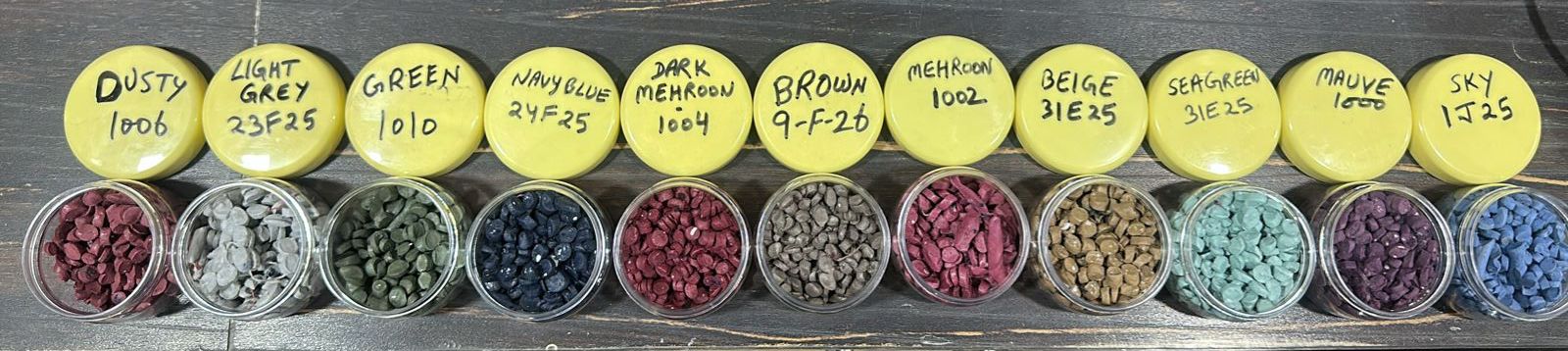 Reprocessed compound shade sample jars arranged with labelled color references